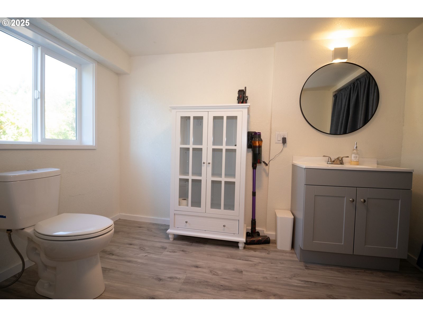 4589 Meares Street Florence, OR 97439 - Photo 29 of 35 a bathroom with a toilet a sink and a mirror