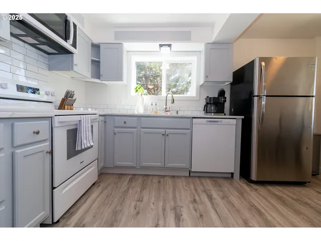 a kitchen with stainless steel appliances granite countertop a stove top oven a sink dishwasher and granite countertops with cabinets