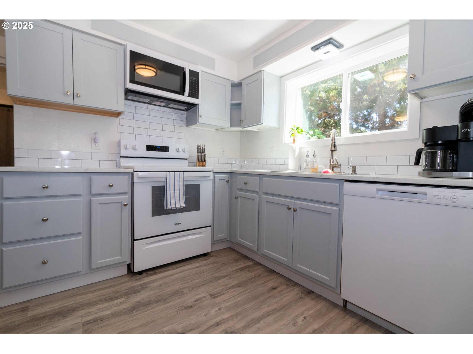 4589 Meares Street Florence, OR 97439 - Photo 34 of 35 a kitchen with cabinets stainless steel appliances a sink and a window