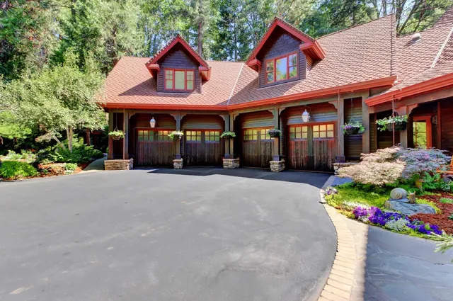 a living room with large windows and a chandelier