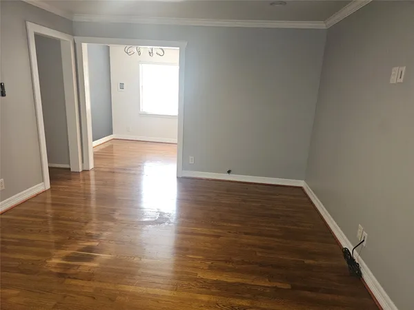 a view of a room with wooden floor and window