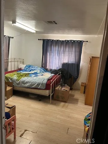 a bedroom with a bed and a chair