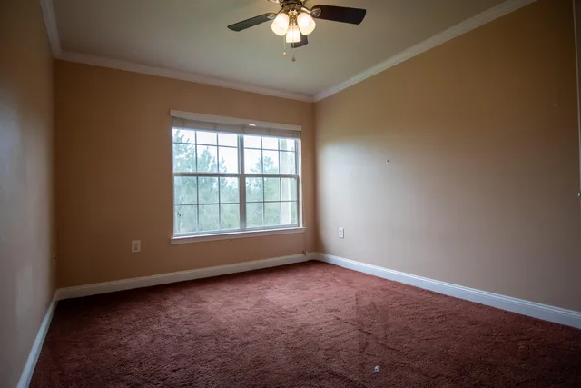 a view of room with window and ceiling fan