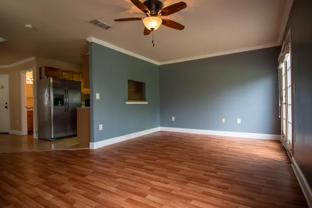 a view of a livingroom with a ceiling fan a hardwood floor and a ceiling fan