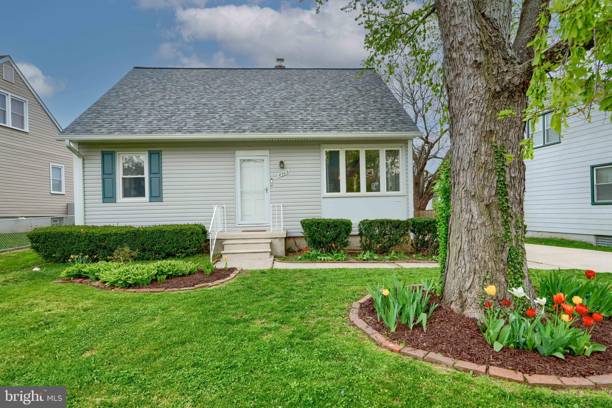 8203 Oakleigh Road Baltimore, MD 21234 - Photo 1 of 56 a front view of a house with a garden
