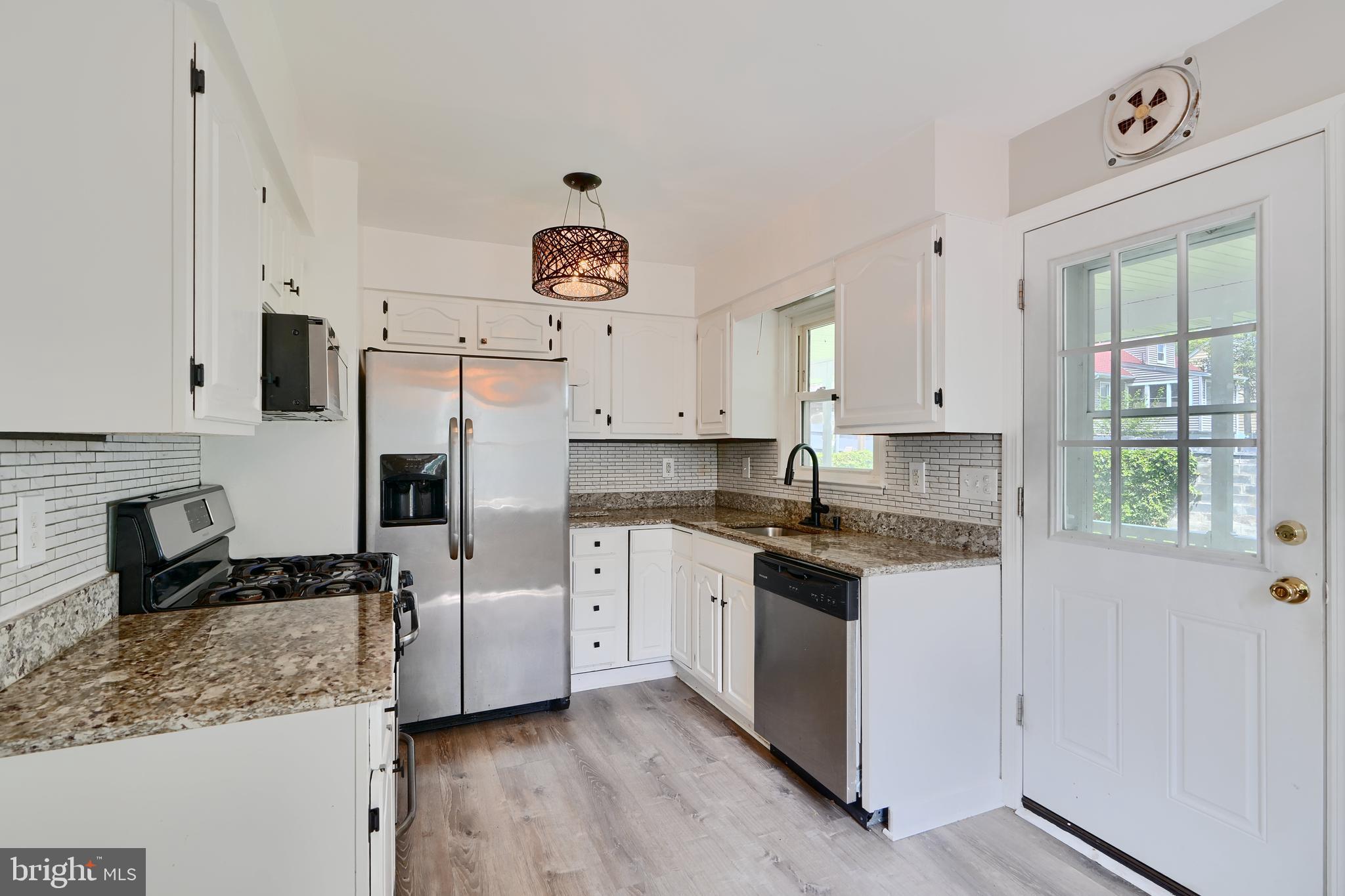 8203 Oakleigh Road Baltimore, MD 21234 - Photo 13 of 56 a kitchen with a refrigerator and cabinets