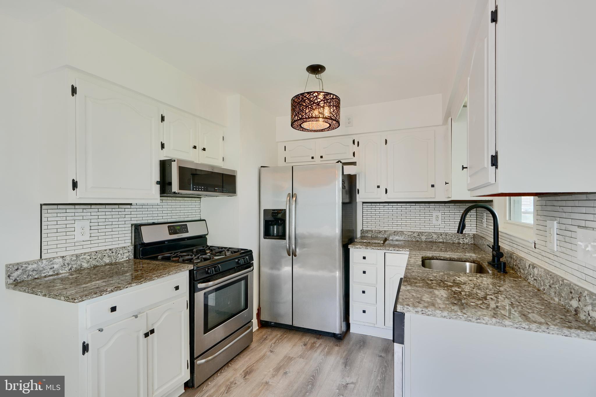 8203 Oakleigh Road Baltimore, MD 21234 - Photo 14 of 56 a kitchen with stainless steel appliances granite countertop a sink stove and refrigerator