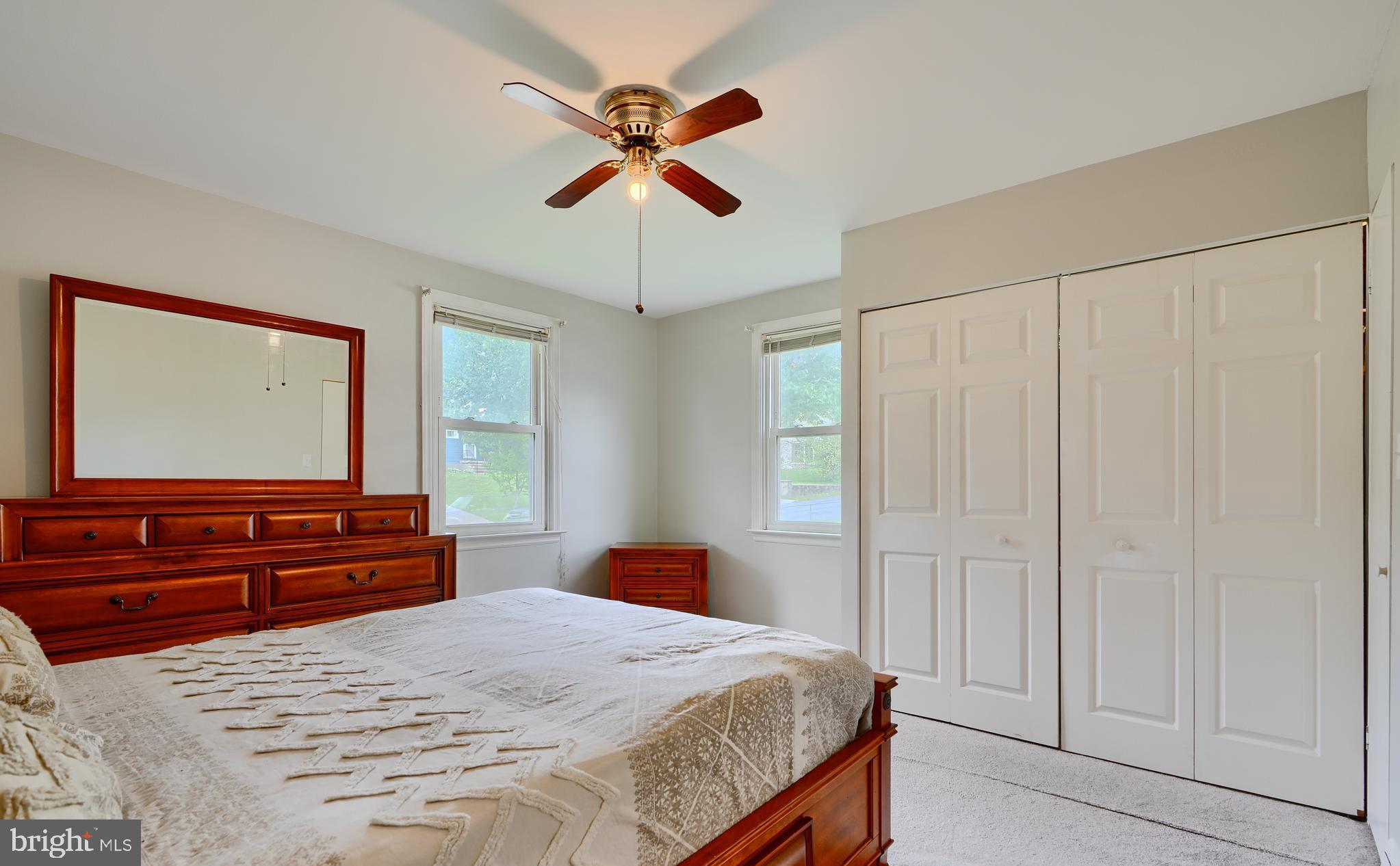 8203 Oakleigh Road Baltimore, MD 21234 - Photo 26 of 56 a bedroom with a bed and a chandelier