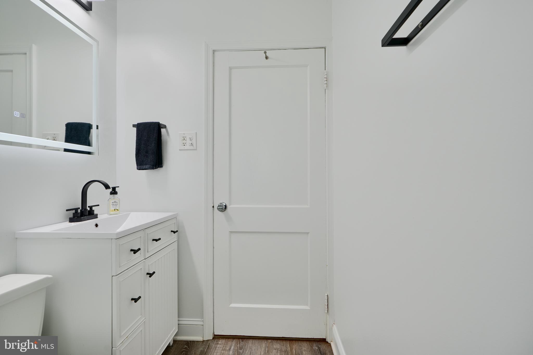 8203 Oakleigh Road Baltimore, MD 21234 - Photo 31 of 56 a bathroom with a sink and a mirror