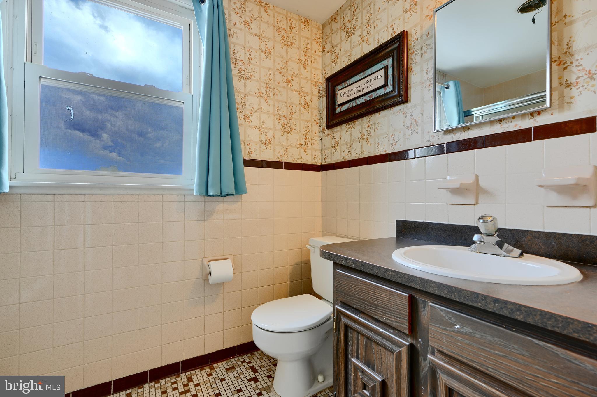 8203 Oakleigh Road Baltimore, MD 21234 - Photo 39 of 56 a bathroom with a sink a toilet and mirror