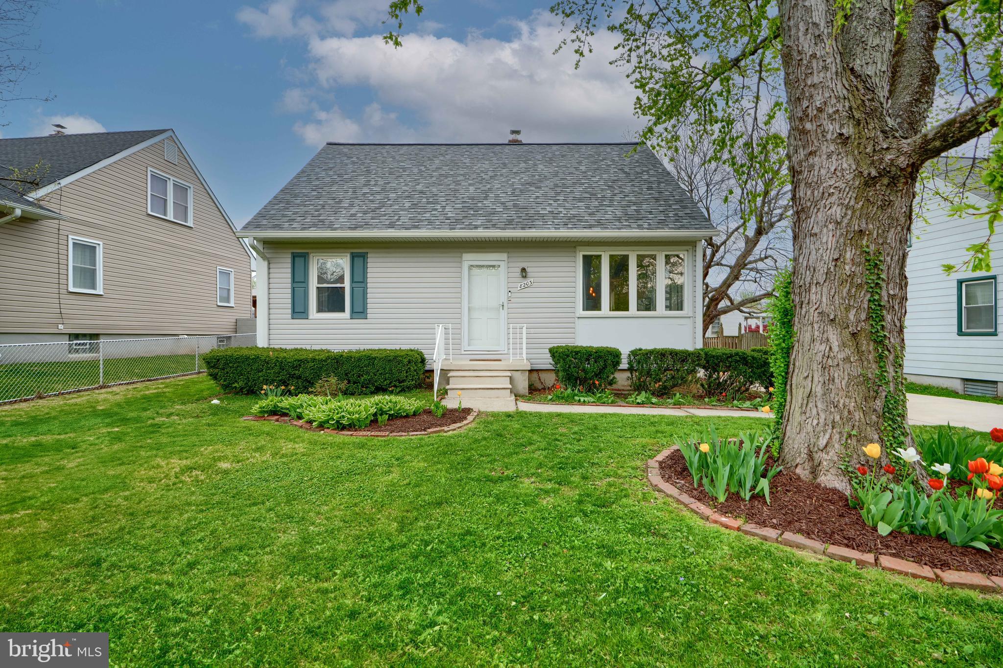 8203 Oakleigh Road Baltimore, MD 21234 - Photo 4 of 56 a front view of a house with a yard and outdoor seating