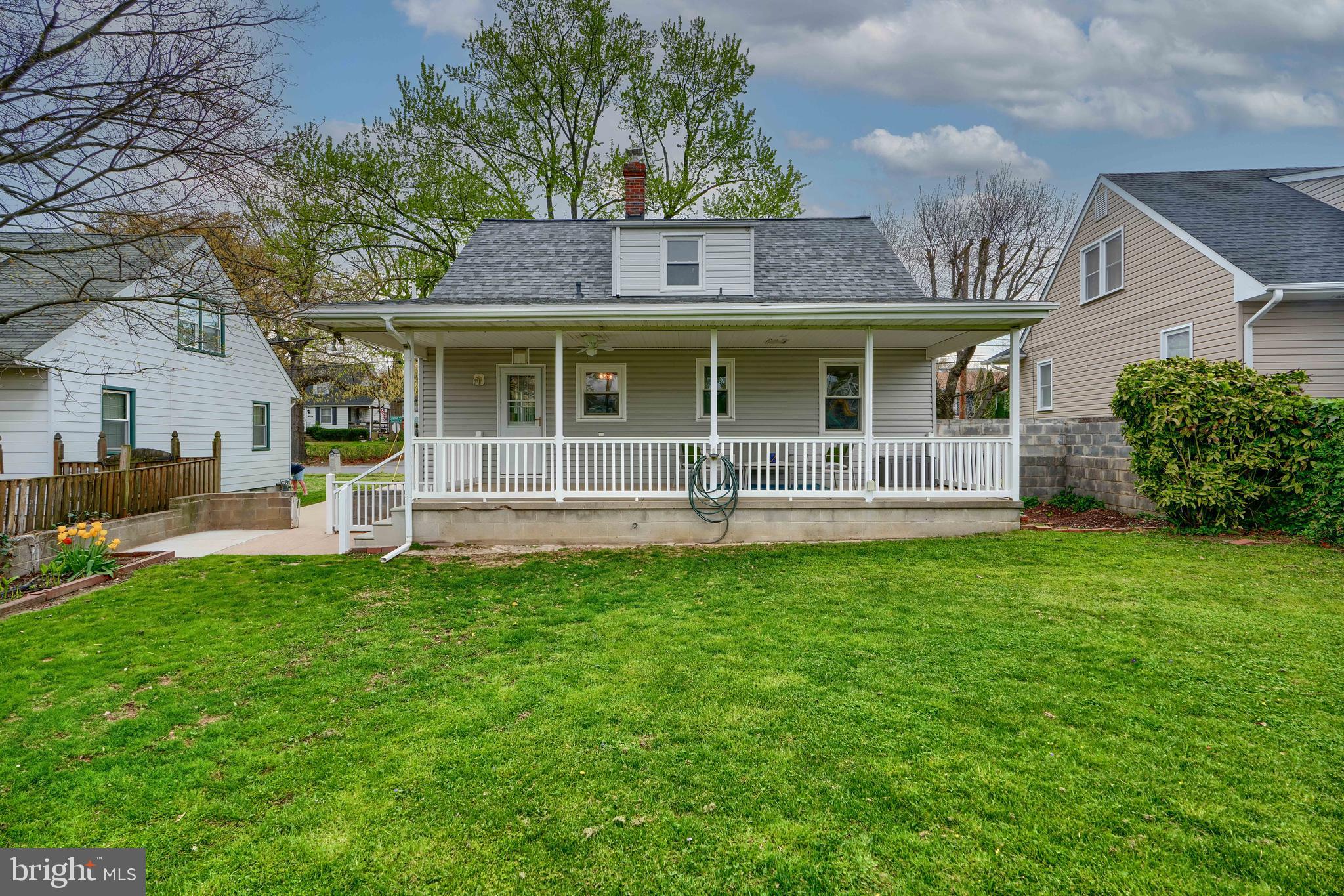 8203 Oakleigh Road Baltimore, MD 21234 - Photo 50 of 56 a front view of a house with a garden