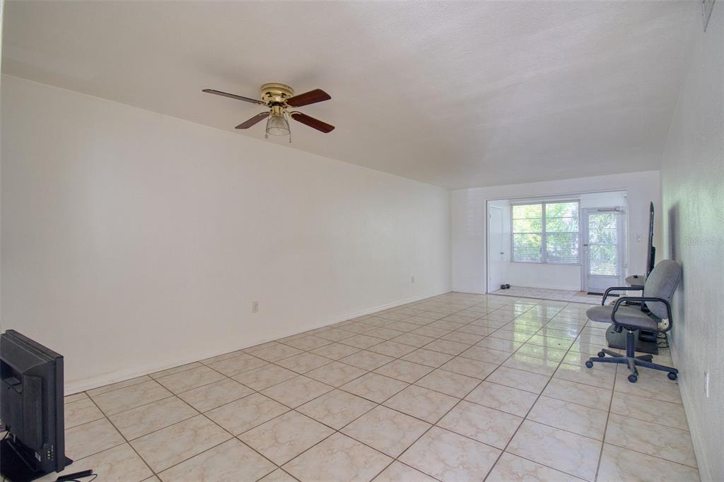 4242 Redcliff Place, Unit C New Port Richey, FL 34652 - Photo 6 of 15 a view of a livingroom with a dinning area hardwood and a window