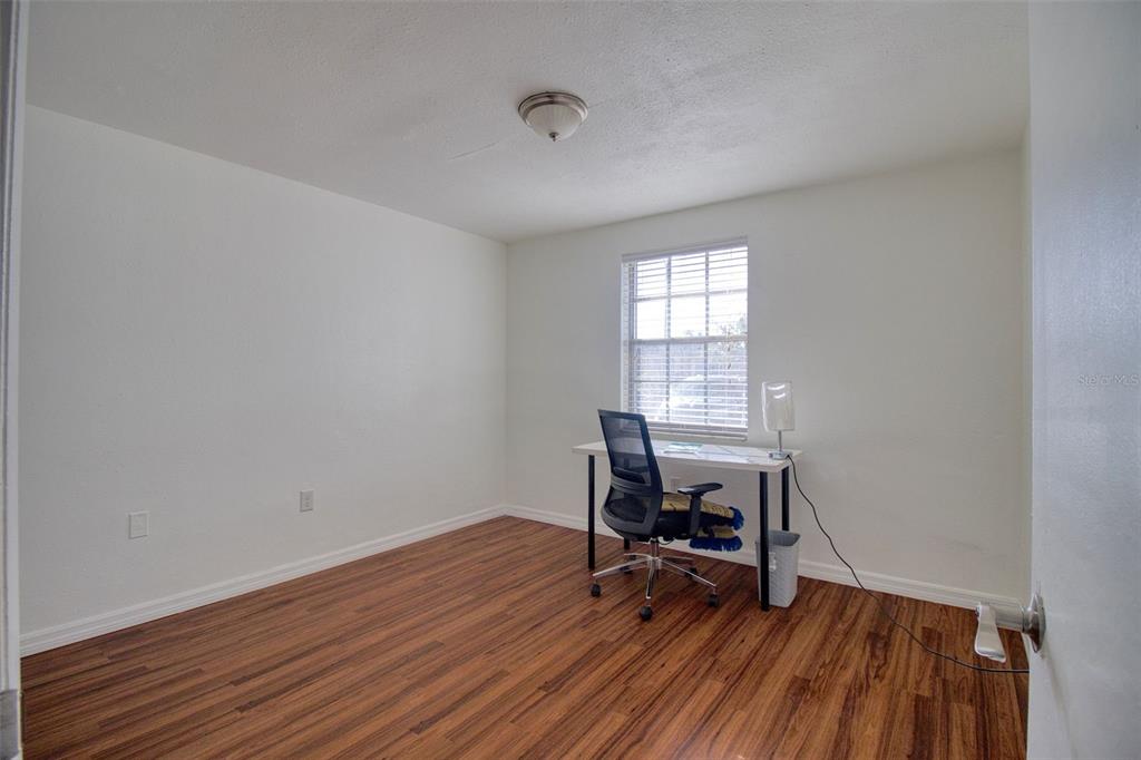 4242 Redcliff Place, Unit C New Port Richey, FL 34652 - Photo 9 of 15 a view of a workspace with wooden floor and a window