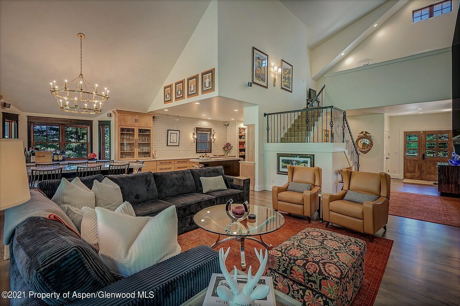 a living room with furniture and a chandelier