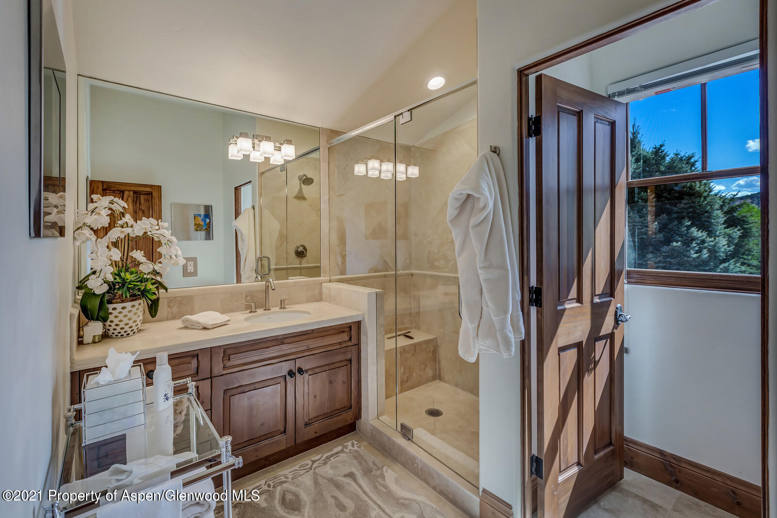 245 Saddleback Road Carbondale, CO 81623 - Photo 14 of 19 a bathroom with a granite countertop sink a mirror a bathtub and shower
