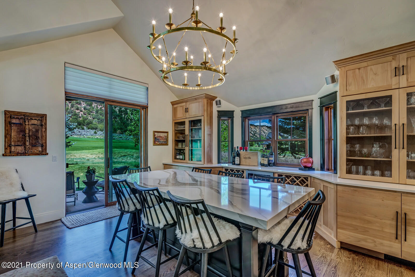 245 Saddleback Road Carbondale, CO 81623 - Photo 7 of 19 a dining room with wooden floor a chandelier a wooden table and chairs