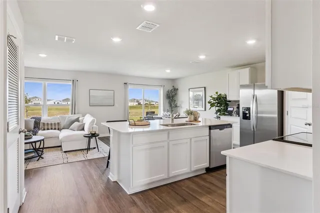 a kitchen with counter top space sink and refrigerator