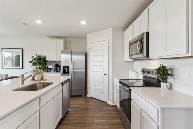 a kitchen with sink cabinets and refrigerator