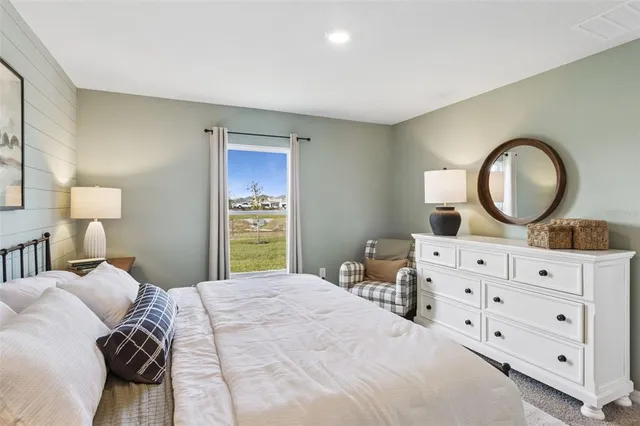 a bedroom with a bed and a dresser