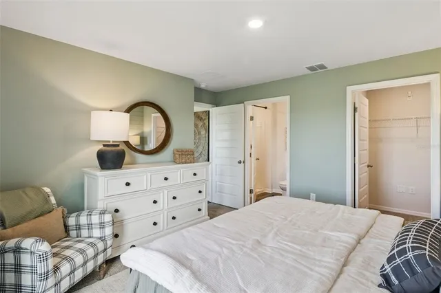 a bedroom with a bed and a dresser