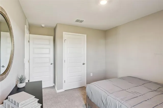 a bedroom with a bed and a mirror