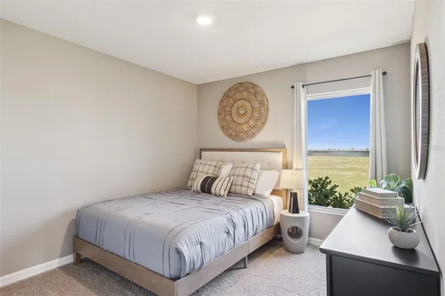 a bedroom with a bed and a chair