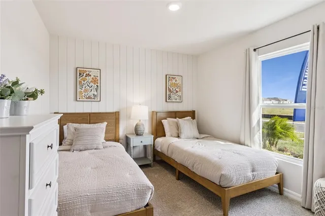 a bedroom with bed and a window