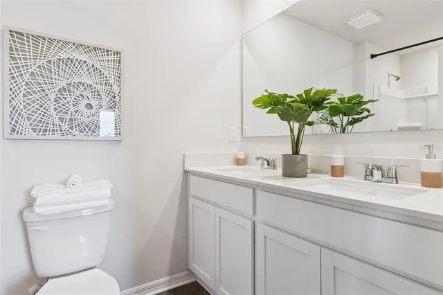 a bathroom with a toilet sink and mirror
