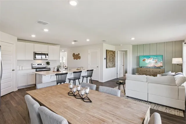 a living room with furniture and kitchen view