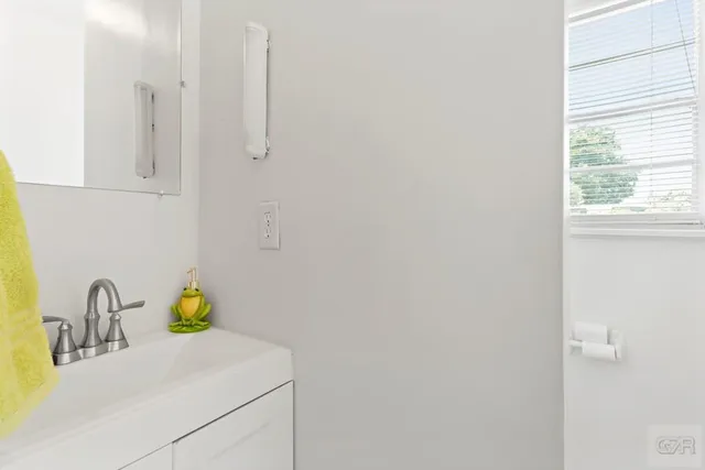 a bathroom with a sink and a window