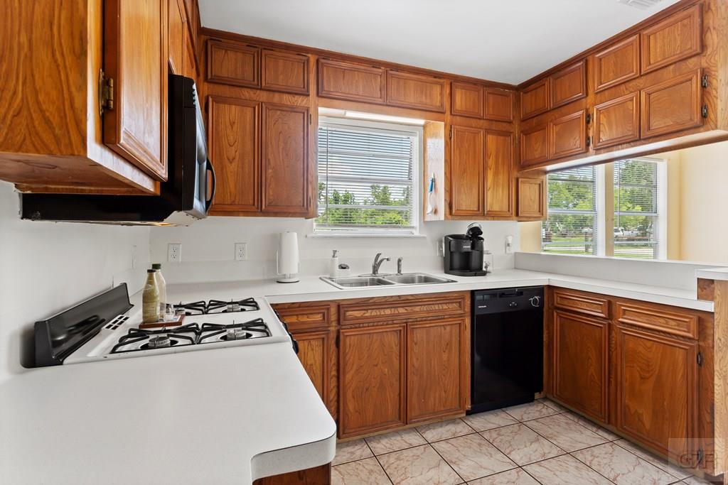 4444 18th Street Bacliff, TX 77518 - Photo 4 of 13 a kitchen with stainless steel appliances granite countertop a stove a sink and a microwave
