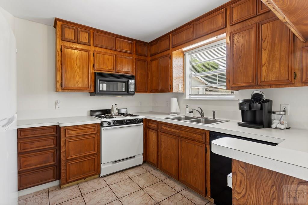 4444 18th Street Bacliff, TX 77518 - Photo 5 of 13 a kitchen with stainless steel appliances granite countertop wooden cabinets sink and a granite counter top
