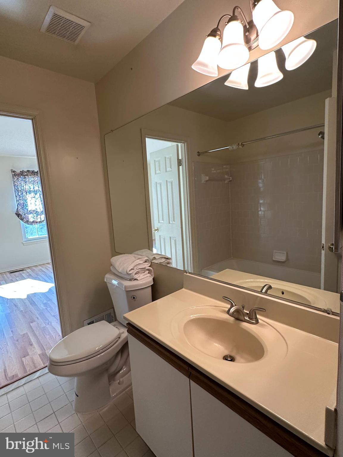 4031 Forest Valley Road Baltimore, MD 21234 - Photo 10 of 19 a bathroom with a toilet sink and mirror