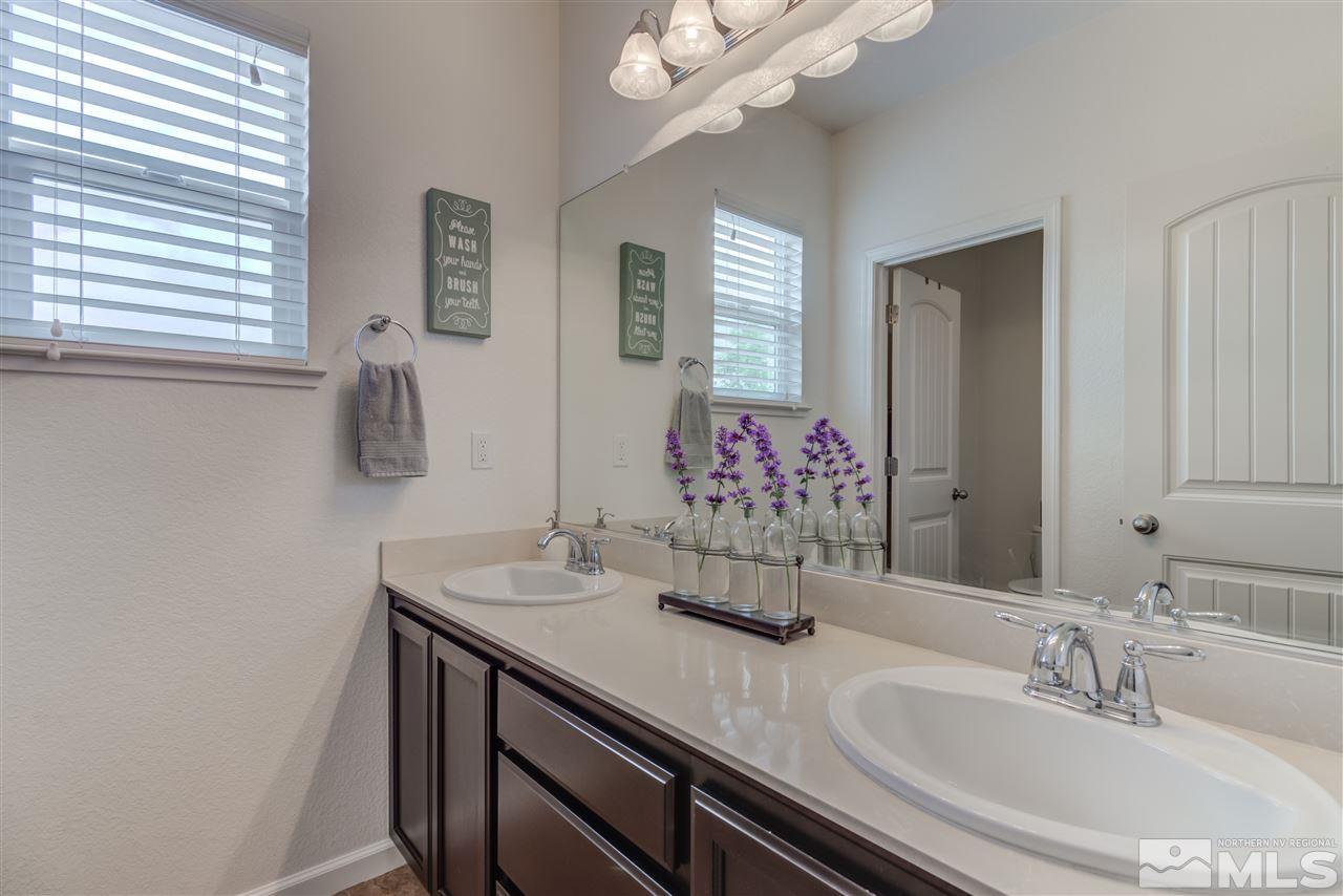 9340 Mill Iron Road Reno, NV 89521 - Photo 20 of 25 a bathroom with a sink vanity and a mirror