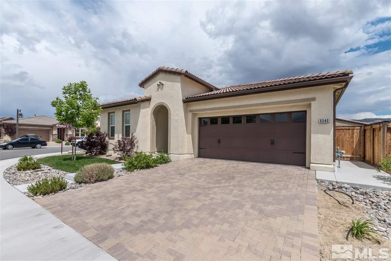 9340 Mill Iron Road Reno, NV 89521 - Photo 2 of 25 a front view of a house with a yard and garage