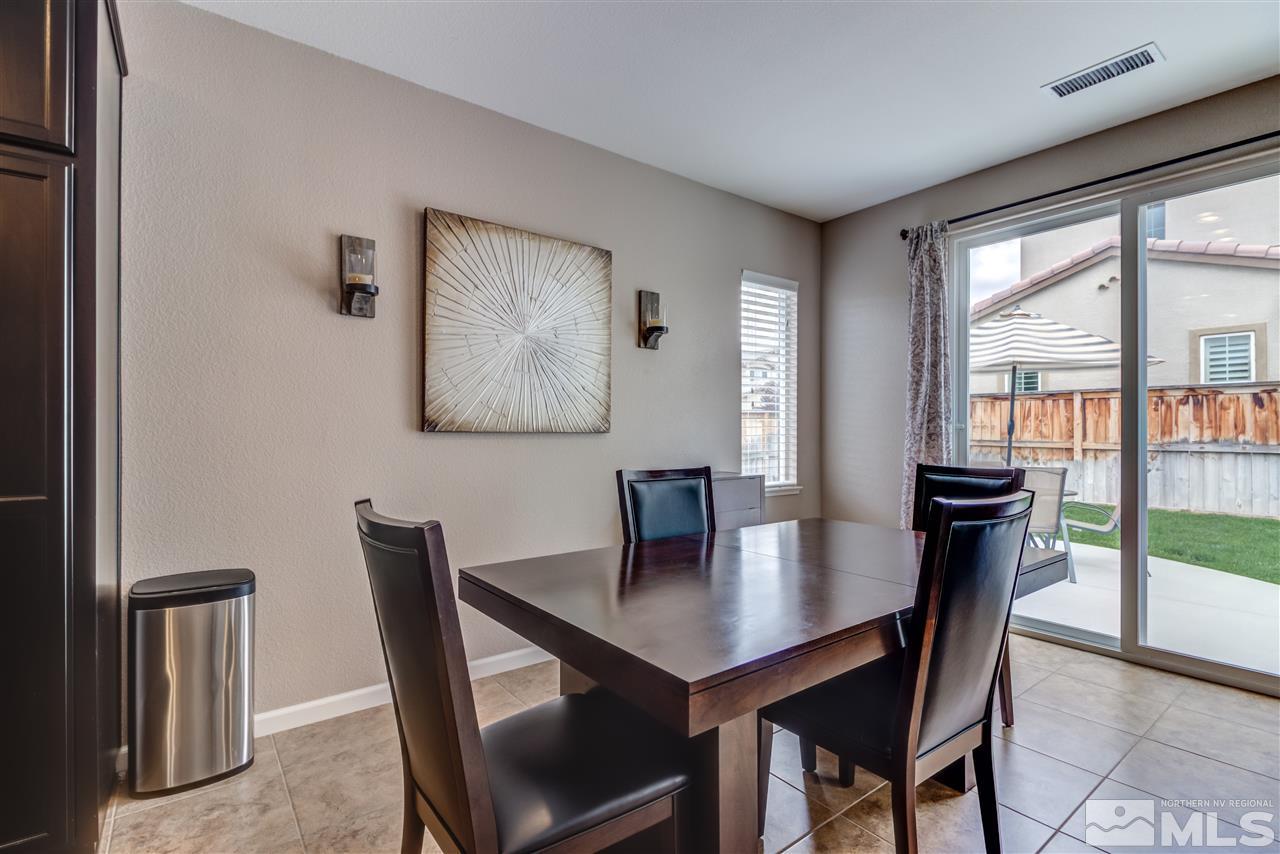 9340 Mill Iron Road Reno, NV 89521 - Photo 7 of 25 a view of a dining room with furniture and a potted plant