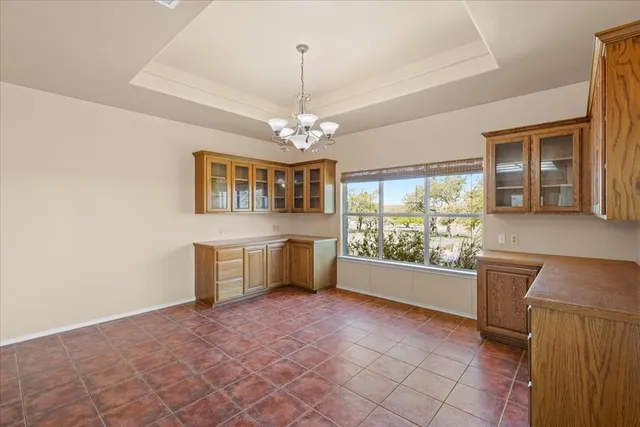 a large kitchen with a stove a sink dishwasher a kitchen island with cabinets and wooden floor