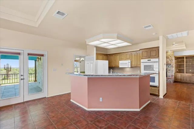 a view of an empty room with a window and a ceiling fan