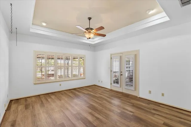 a spacious bathroom with a granite countertop double vanity and a large mirror