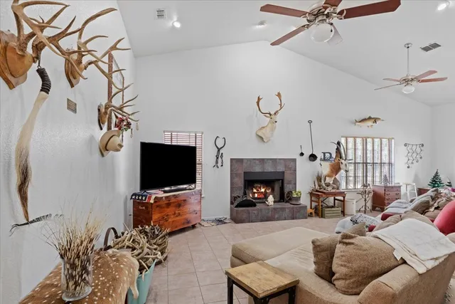 a bedroom with a bed flat screen tv and a window