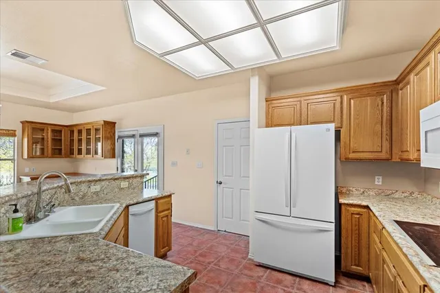 a kitchen with stainless steel appliances a sink dishwasher and cabinets with wooden floor