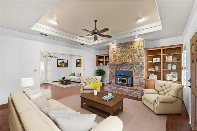 a living room with furniture fireplace and a large window