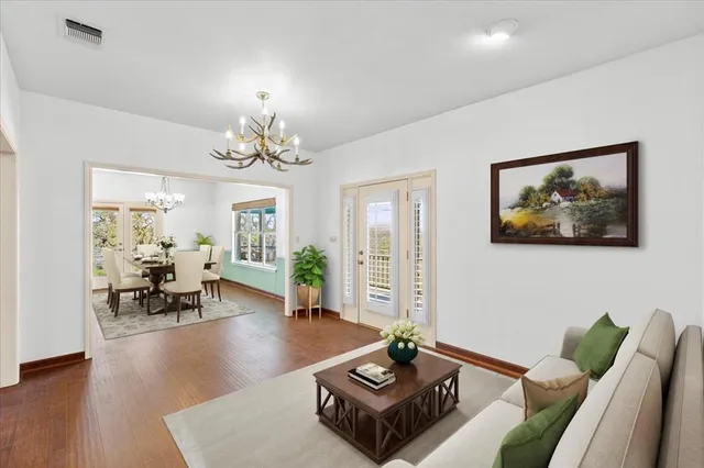 a living room with furniture and a chandelier