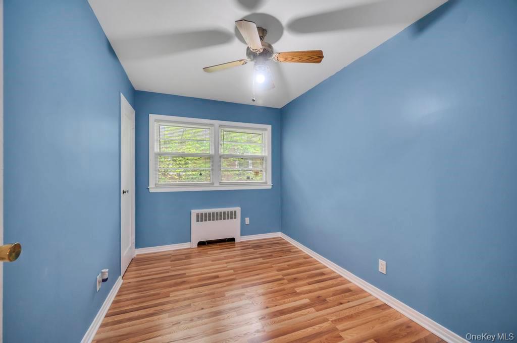 51 Stevenson Road Hewlett, NY 11557 - Photo 12 of 21 Unfurnished room with radiator, wood finished floors, and a ceiling fan