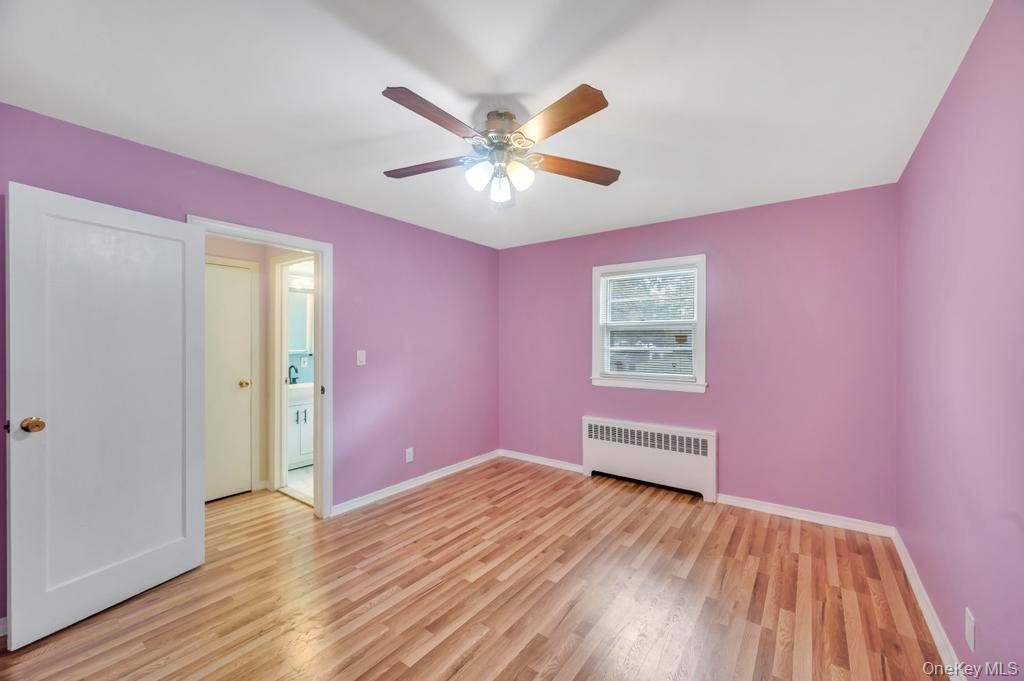 51 Stevenson Road Hewlett, NY 11557 - Photo 14 of 21 Unfurnished bedroom featuring radiator, light wood-style floors, and ceiling fan