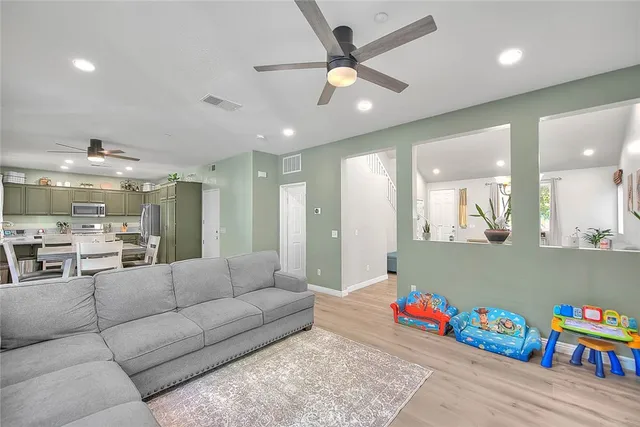 a living room with furniture and kitchen view