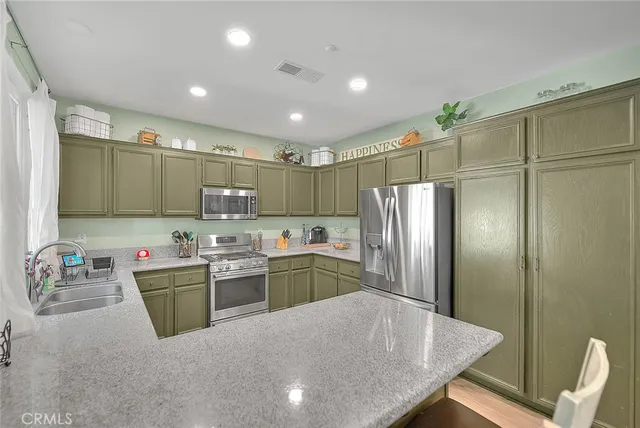 a kitchen with sink refrigerator and microwave