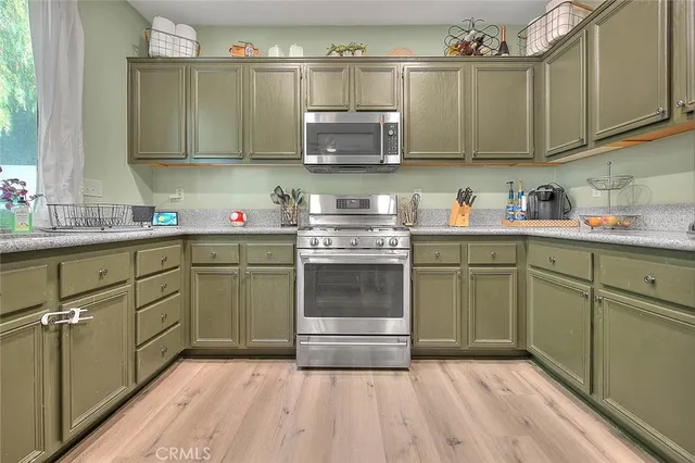 a kitchen with stainless steel appliances a stove sink and cabinets