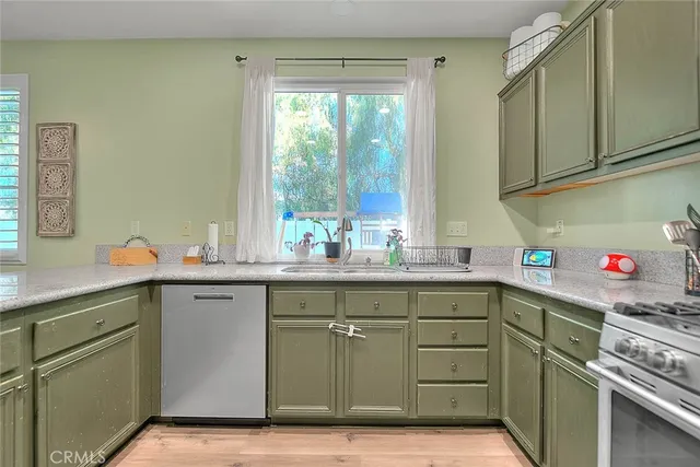 a kitchen with a sink cabinets and window